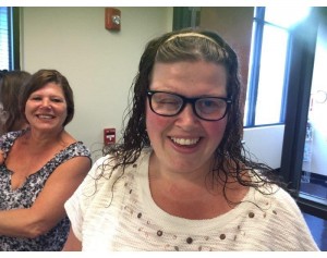 The remarkable Tiffany, with her mom in the background, showing her positive spirit before surgery